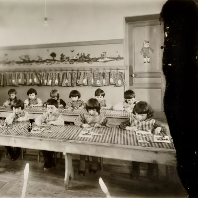 Photographie en noir et blanc d'enfants dans une classe (19FI724, Archives départementales de l'Isère).